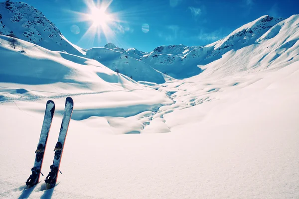 Skis in snow in mountains