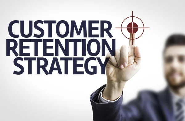 Business man pointing to transparent board with text: Customer Retention Strategy