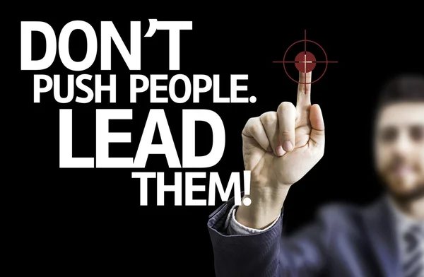 Business man pointing the text: Don't Push People, Lead Them!