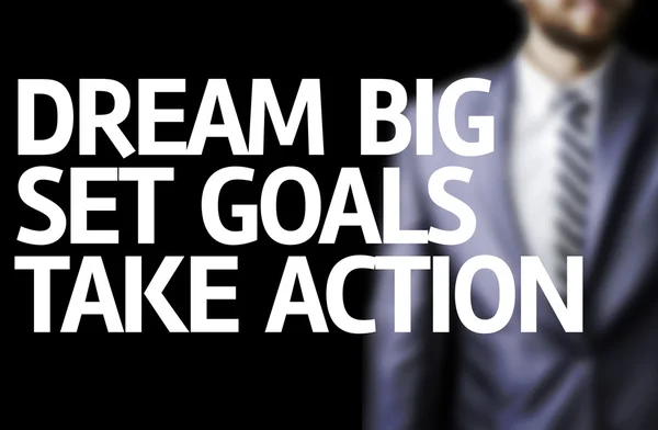 Dream Big Set Goals Take Action written on a board