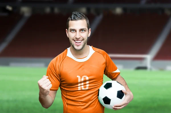 Soccer fan celebrates in orange t-shirt