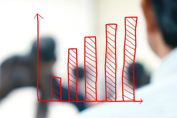 Growth bar chart with blurred business people background