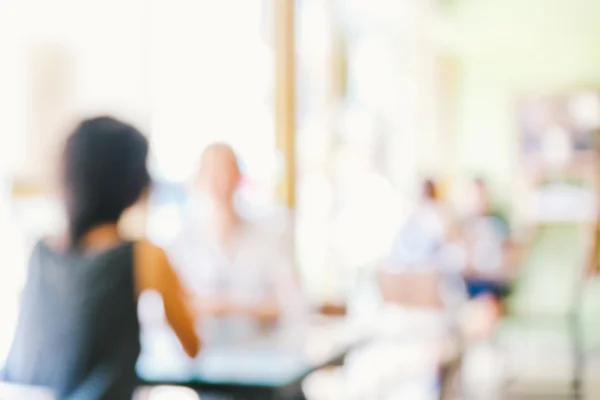 Blurred background of talking people in restaurant