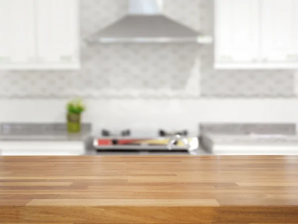Empty wooden table and blurred kitchen background