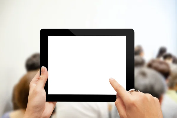 Close-up hand using digital tablet with blank screen against blu