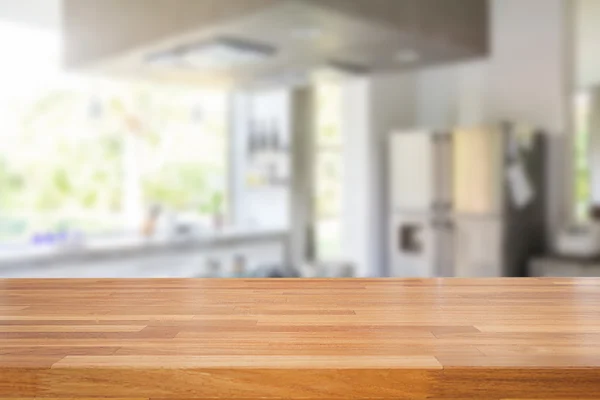 Empty wooden table and blurred kitchen background