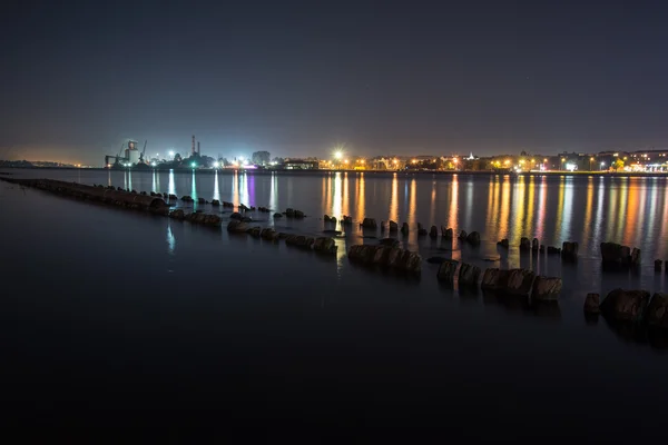 Summer night city light reflections over water