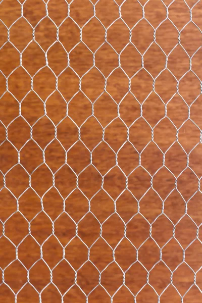 Wire mesh on orange wall