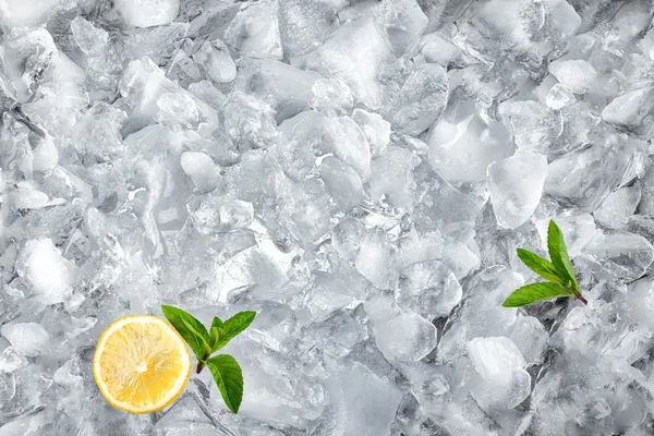 Background with ice cubes mint and lemon, top view