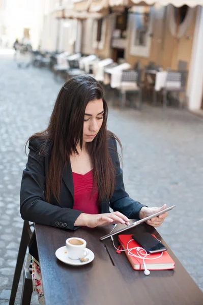 Business woman with tablet at coffee bar