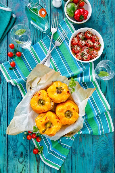 Roasted yellow bell  peppers stuffed with quinoa, mushrooms and cheese. Cherry tomatoes baked with parmesan