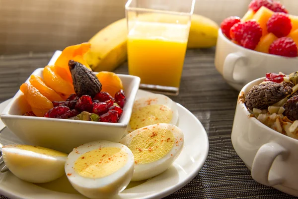 Fresh fruit and oatmeal with healthy toppings for breakfast