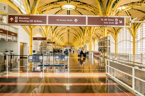 Passengers walking through a bright airport