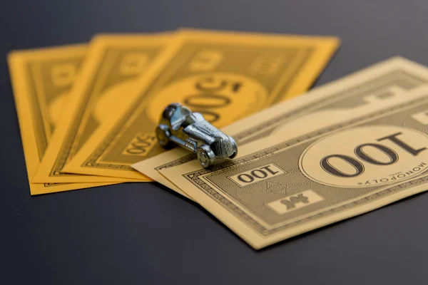 February 8, 2015: Houston, TX, USA.  Monopoly car and money