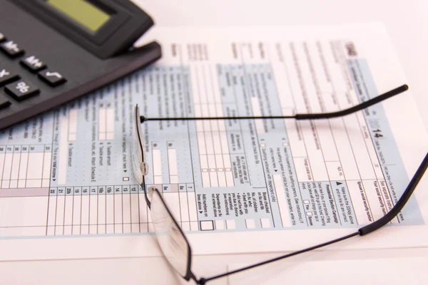 Tax preparation supplies, reading glasses and tax forms