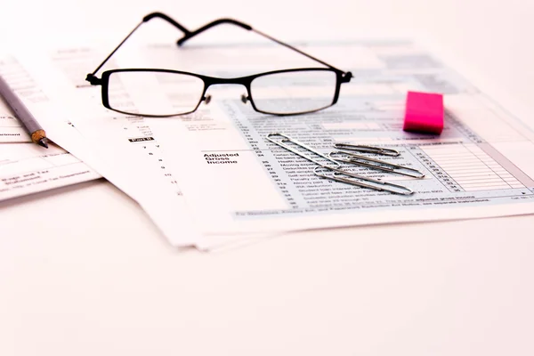 Tax preparation supplies, reading glasses and tax forms