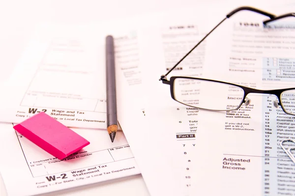 Tax preparation supplies, reading glasses and tax forms