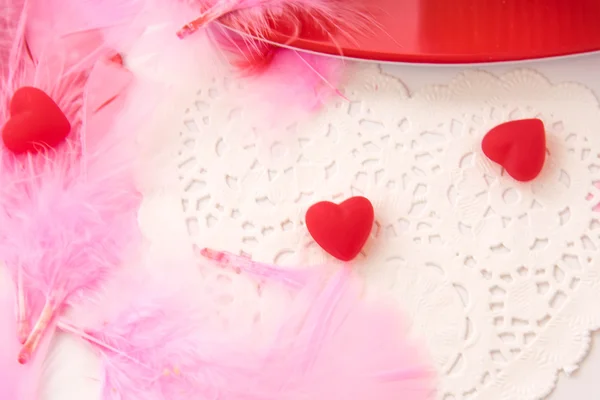 Valentines Day - decorations, pink feathers and heart shaped can
