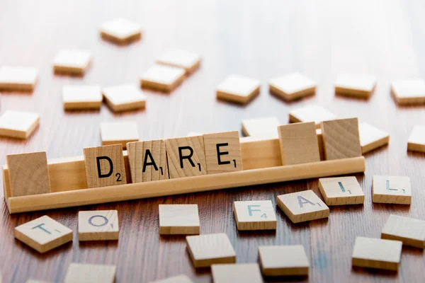 Scrabble Word Game wood tiles spelling DARE TO FAIL