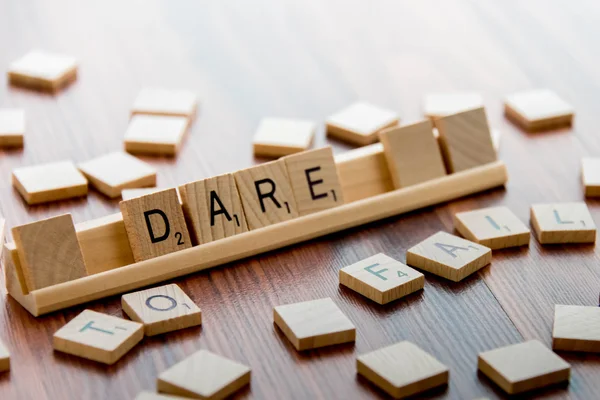 Scrabble Word Game wood tiles spelling DARE TO FAIL