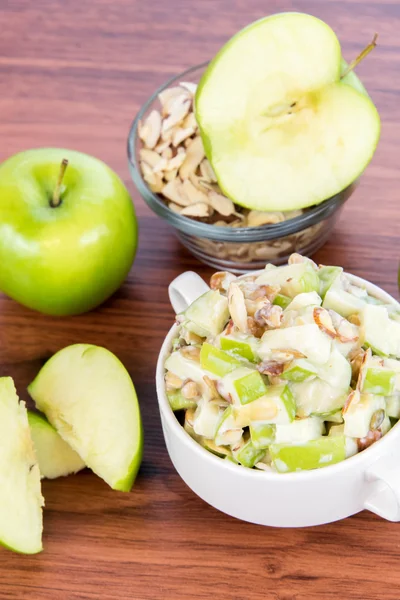 Apple salad with almonds, walnuts and pumpkin seeds