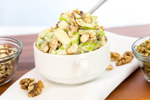 Apple salad with almonds, walnuts and pumpkin seeds