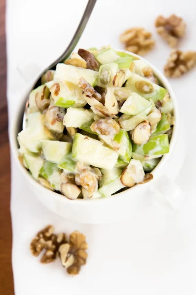 Apple salad with almonds, walnuts and pumpkin seeds