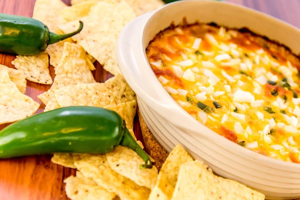 Hot bean dip with jalapenos, sour cream and melted cheddar chees