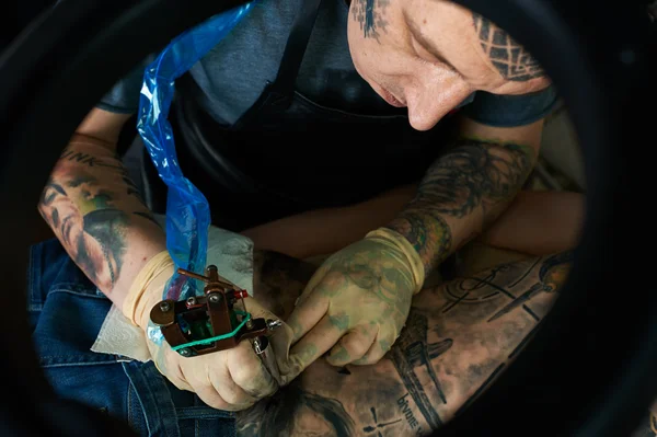 Tattoo artist in studio. Closeup