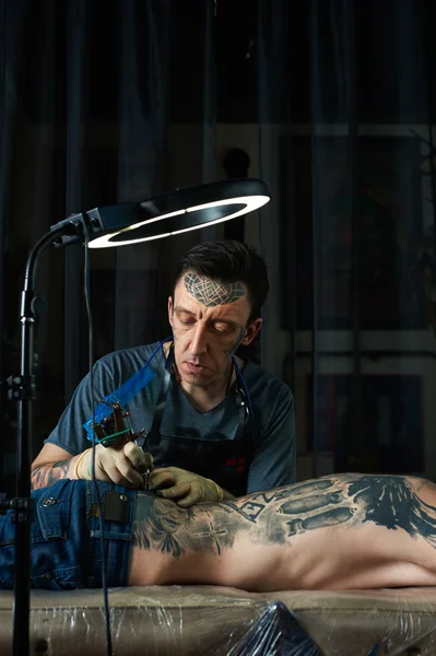 Tattooist creates a design of tattoo