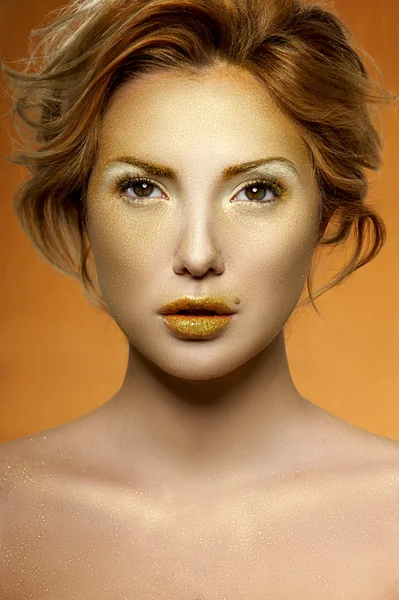 Golden Makeup on Face of fashion beauty Female Model