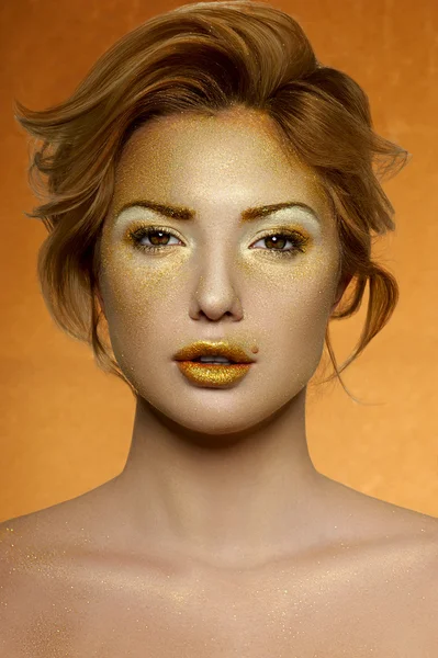 Fashion beauty Female Model with gold Face