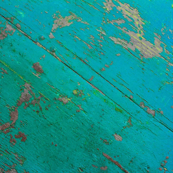 Background texture of the old ultra turquoise painted board in the cracks. square photo with copy space for text