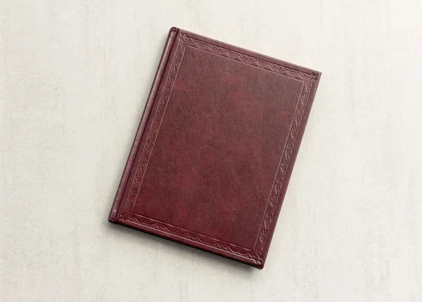 Book red on a grey background, top view