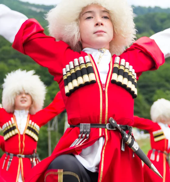 Children in the Circassian national costumes dance traditional dances Adygei. Ethnic festival in the foothills of the Western Caucasus in Adygea