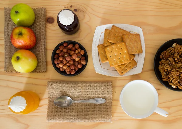 Apples, hazelnuts, biscuits, walnuts, honey, milk and blueberry jam with marshmallows for Breakfast. Natural products for dessert