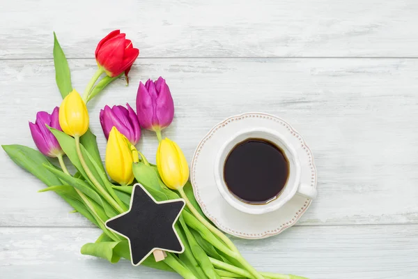 Colorful tulips with star shaped clip and coffee