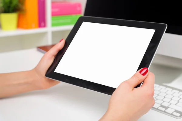 Person in office holding blank screen tablet