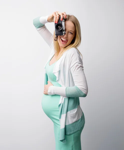 Funny pregnant woman taking pictures