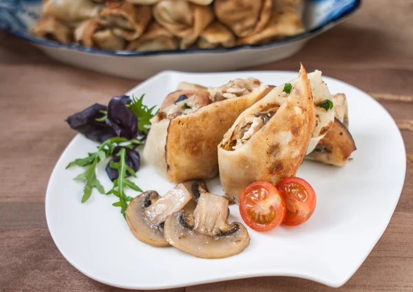 Pancakes stuffed with chicken and mushrooms