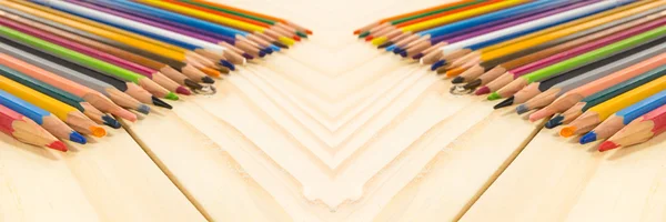 Panorama colored pencils angle/Many different colored pencils on wood background