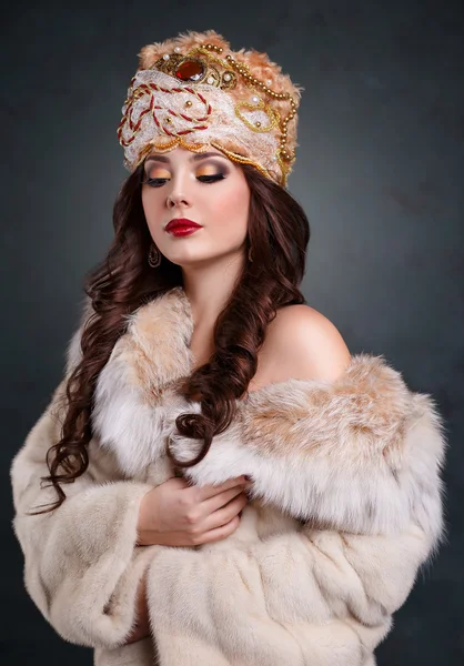 Queen in royal dress. sexy girl in royal hat and fur coat