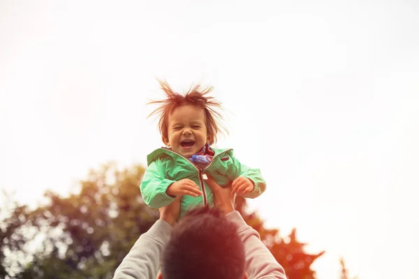 Father lifting up cheerful son in the air