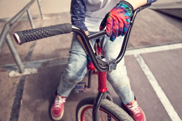 Young BMX rider boy sitting on a bicycle