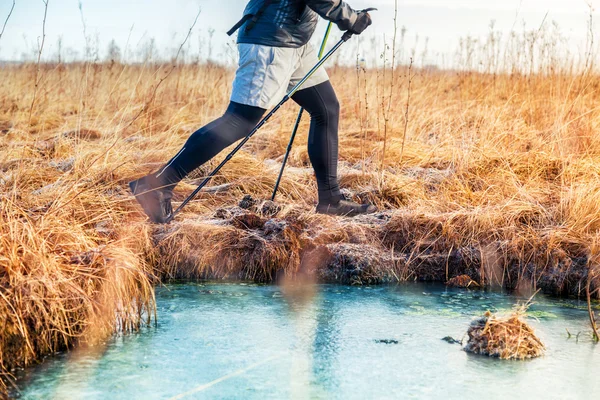 Men trail walking near the frozen river