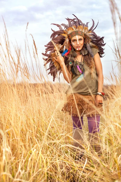 Native American Indian girl dressed in national clothes smile with white teeth in field