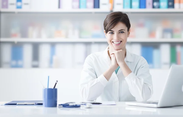 Doctor working at office desk