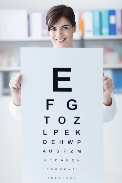 Professional oculist holding an eye chart