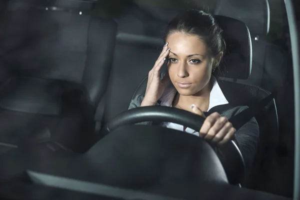 Woman with headache driving