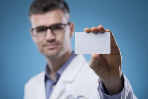 Smiling doctor with business card